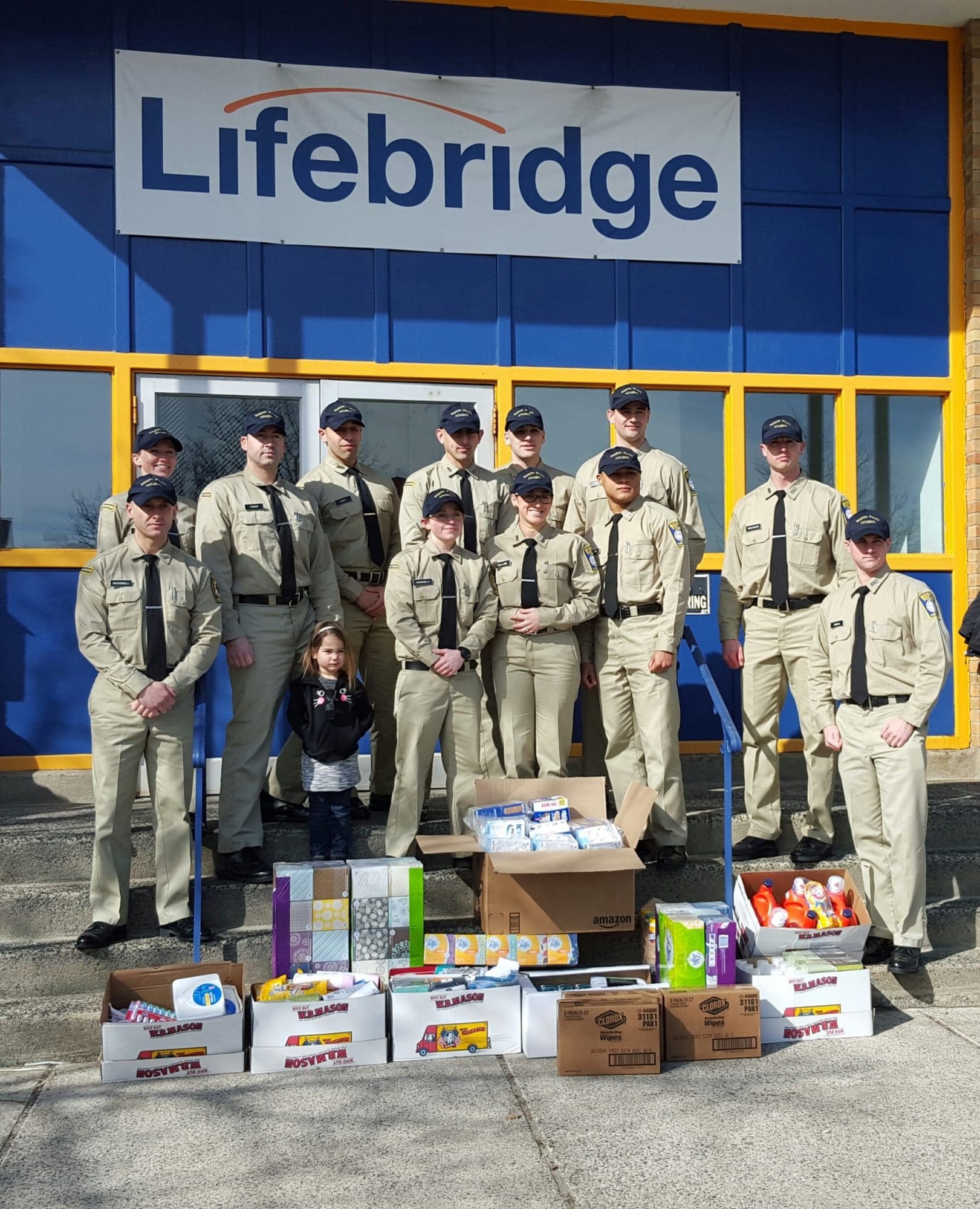 Boston Police Department Academy members stand with donations.