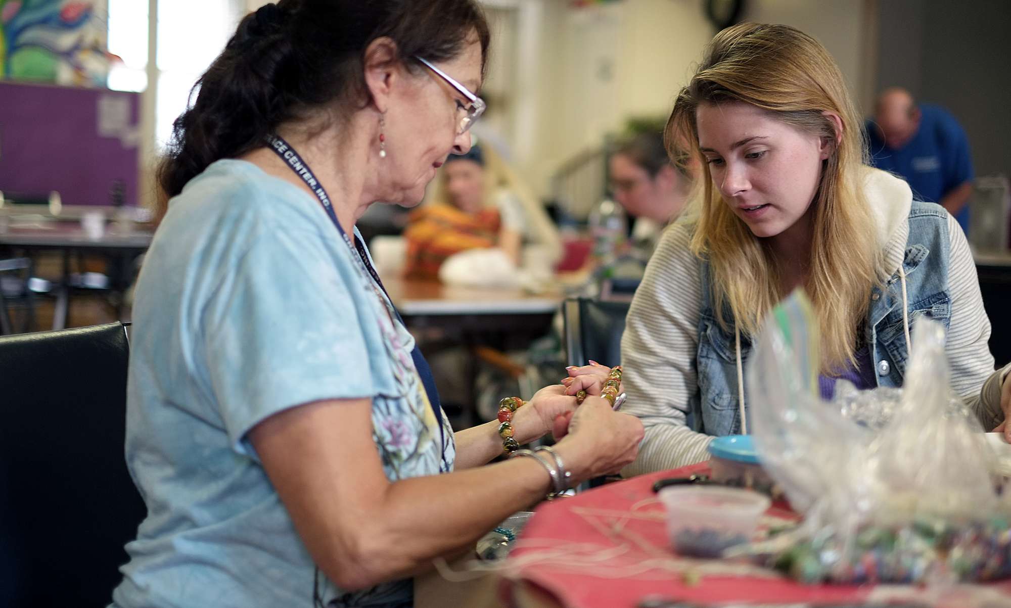 A group of guests embrace at "Together for Women"