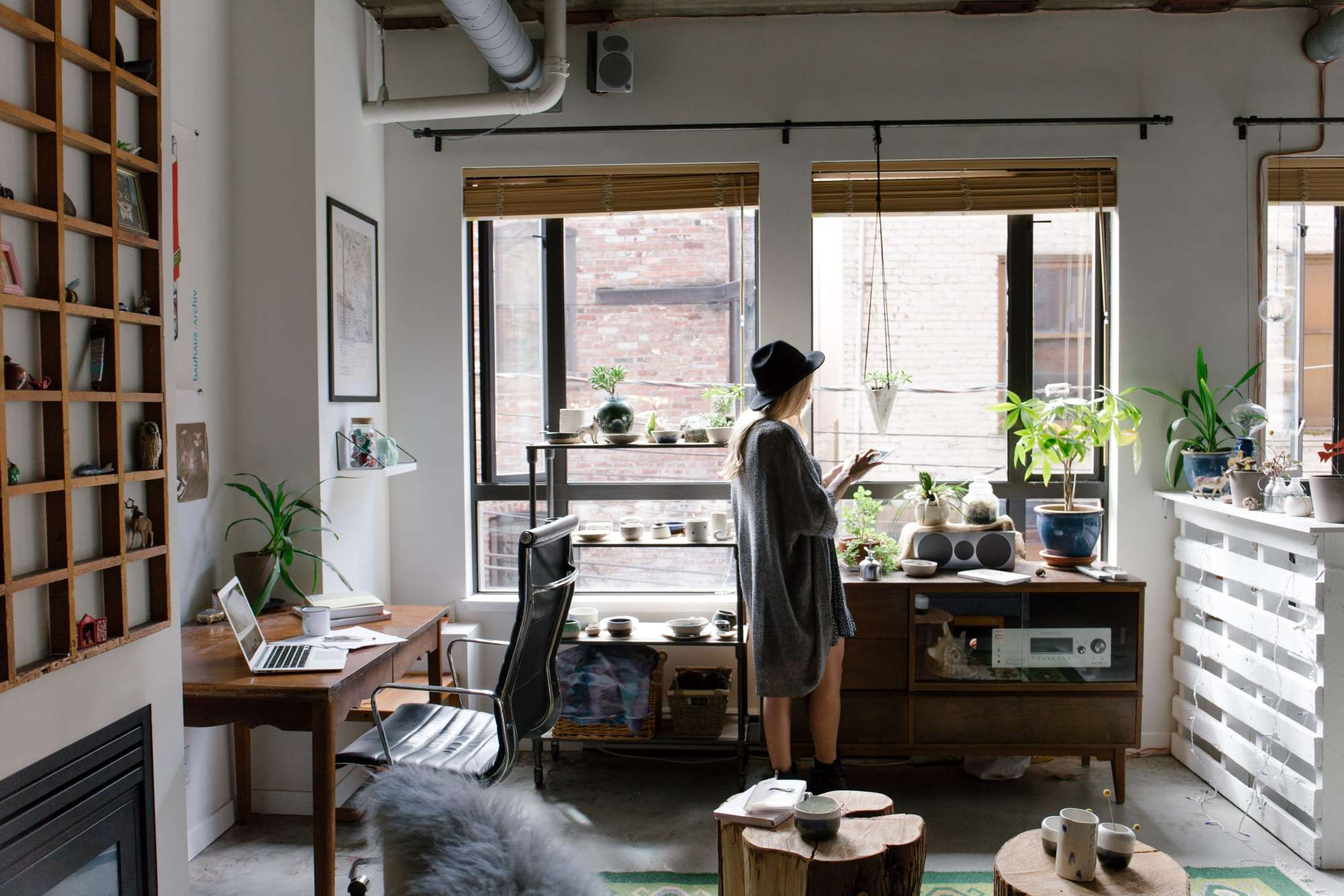 A woman standing by windows