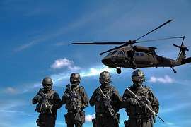 Army soldiers watching a helicopter
