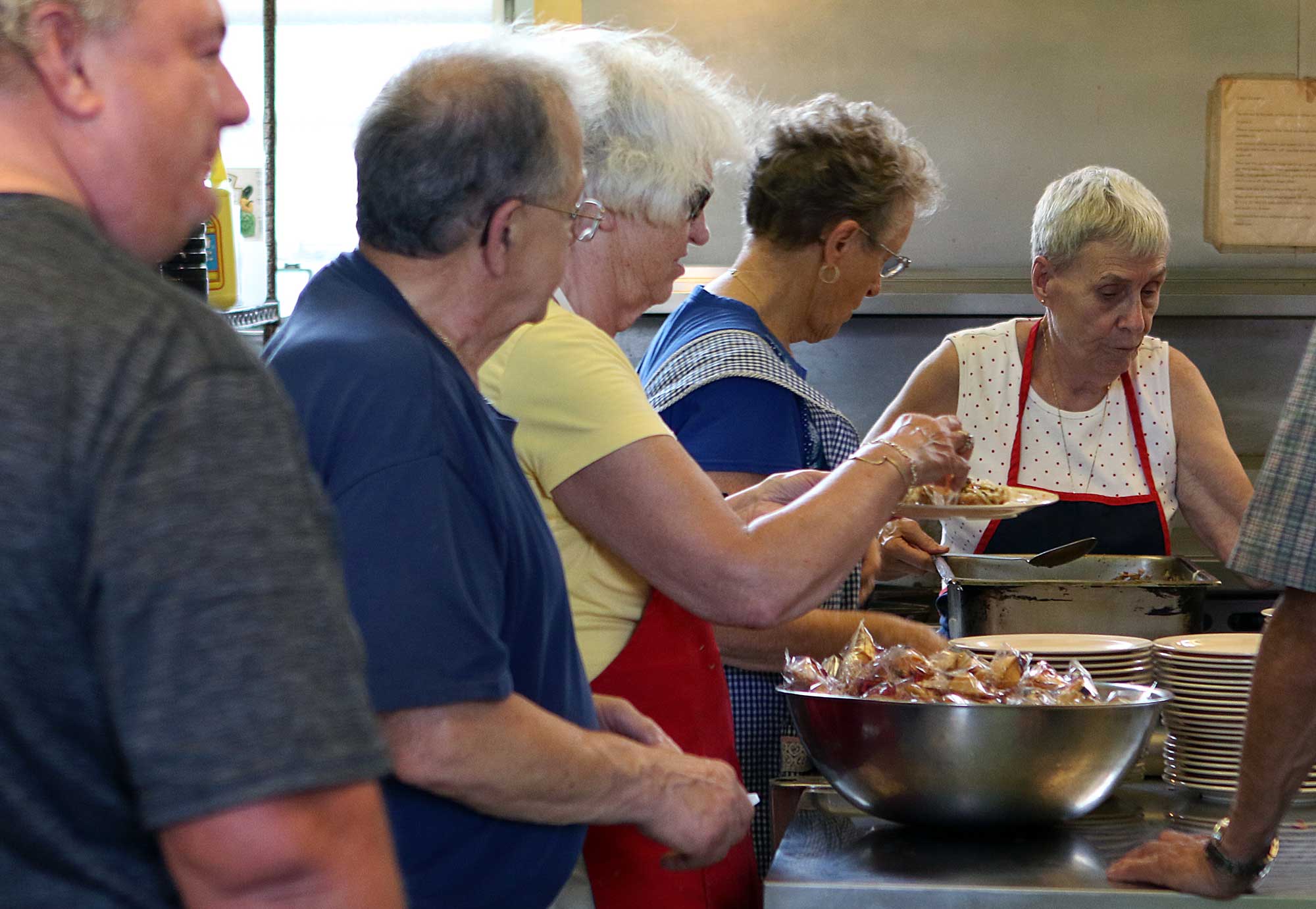 people helping with community meals