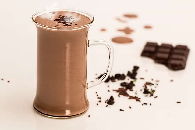 A stock photograph of a glass mug of hot chocolate.