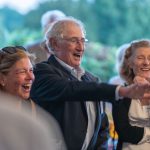 Bob Bourdo and guests smile and laugh at Breaking Bread, Building Hope