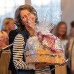 A guest wins a surprise raffle at the Breaking Bread, Building Hope Fund-a-Need event