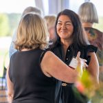Photo of Chief of Staff Tina Holmes talking to a guest at Breaking Bread, Building Hope