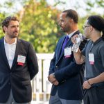 A photo of Director of Community-Based Case Management Jeron Reddick, Case Manager Marquis Smith, and Lifebridge staff member talking at Breaking Bread, Building Hope