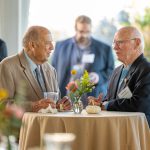 Guests talk at a table at Breaking Bread, Building Hope