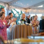 Guests applaud a speech at Breaking Bread, Building Hope