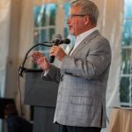 Al Tempkin begins Fund a Need paddle raising event at Breaking Bread, Building Hope