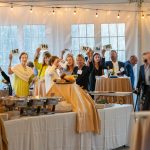 Guests raise their paddles at Breaking Bread, Building Hope