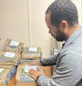 Jeron Reddick, Director of Case Management, prepares food donations.
