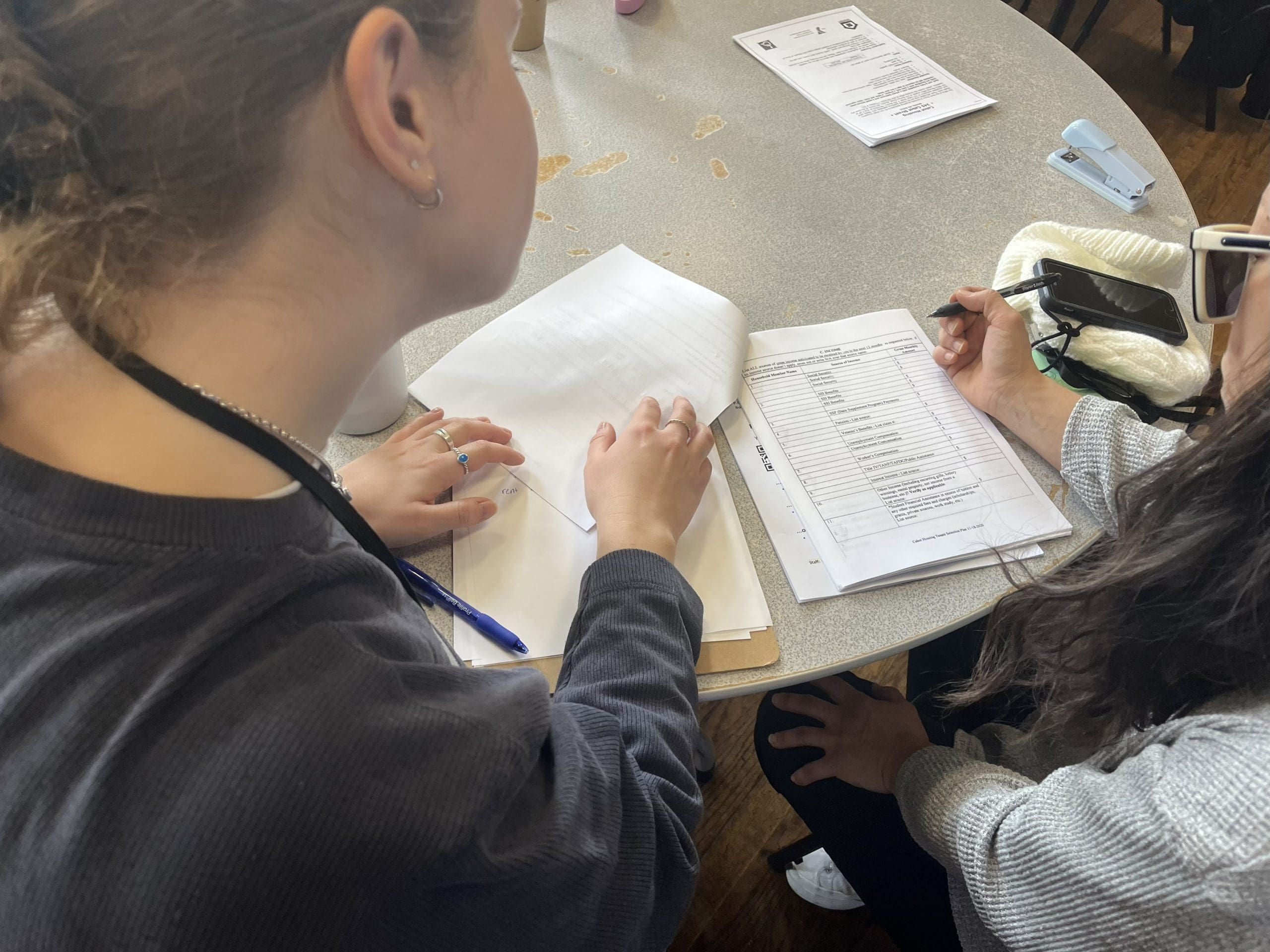 A case manager helps a client fill out a housing application
