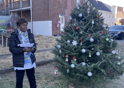Woman standing next to the decorated Christmas tree