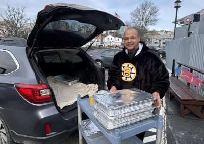Man packing up car with meals