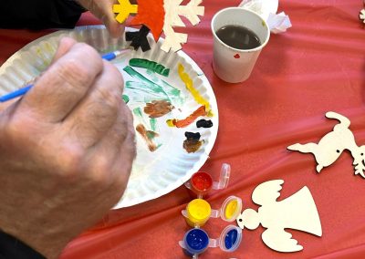 Person painting a snowflake ornament