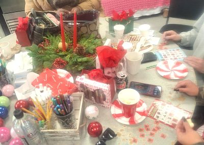 Decorated table with people playing Christmas bingo