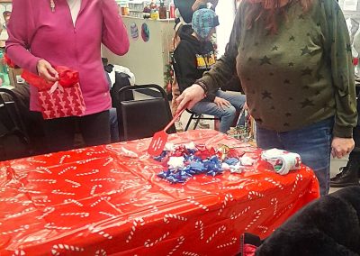 Women playing ribbon bow game.